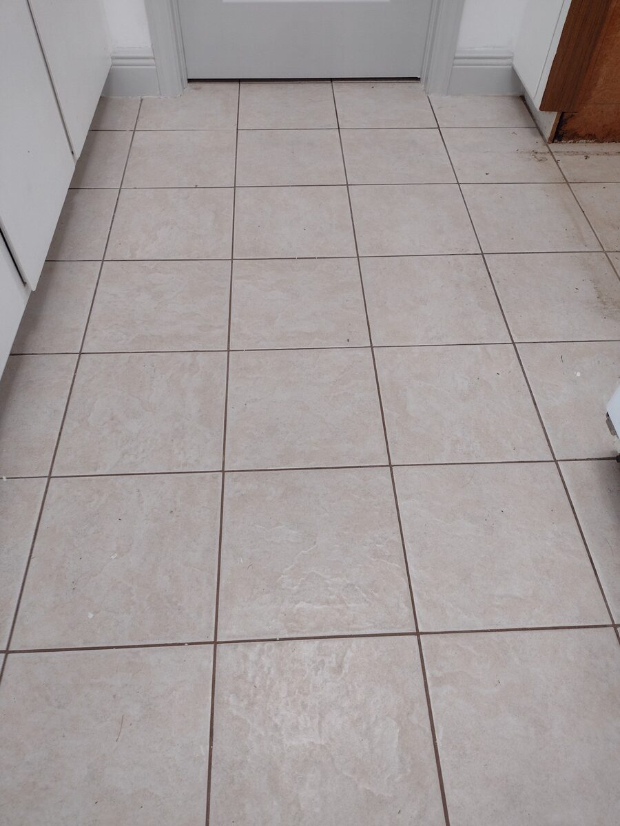 Entryway tile floor before color sealing
